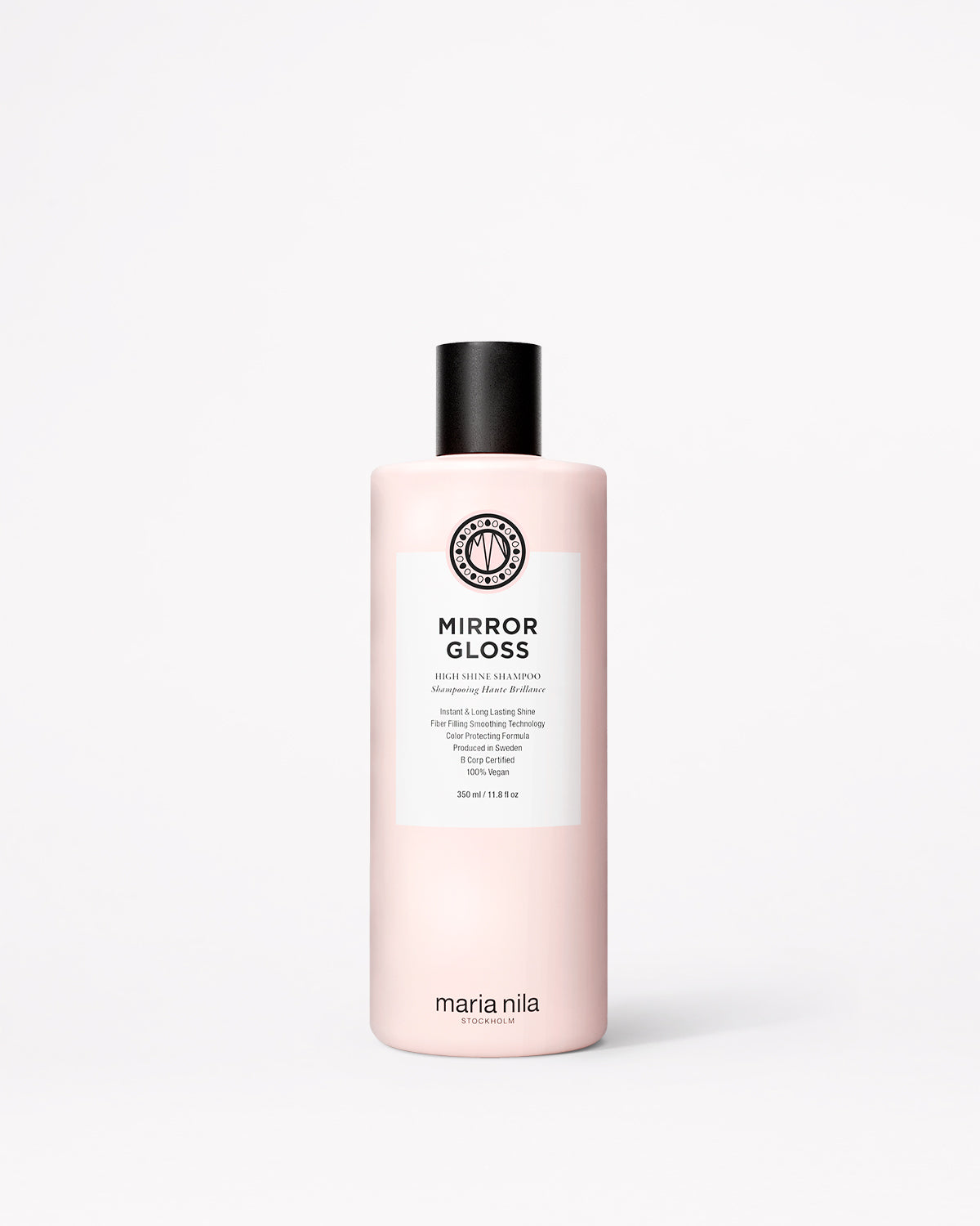 A bottle of Maria Nila Mirror Gloss Shampoo in a pale pink bottle with a black cap and white label, centered on a light gray background.