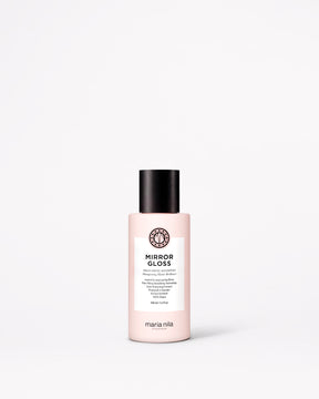 A bottle of Maria Nila Mirror Gloss Shampoo in a pale pink bottle with a black cap and white label, centered on a light gray background.