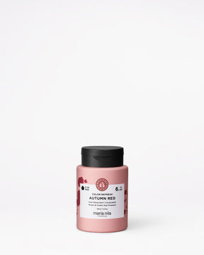 Pink hair color product with black lid on a white background