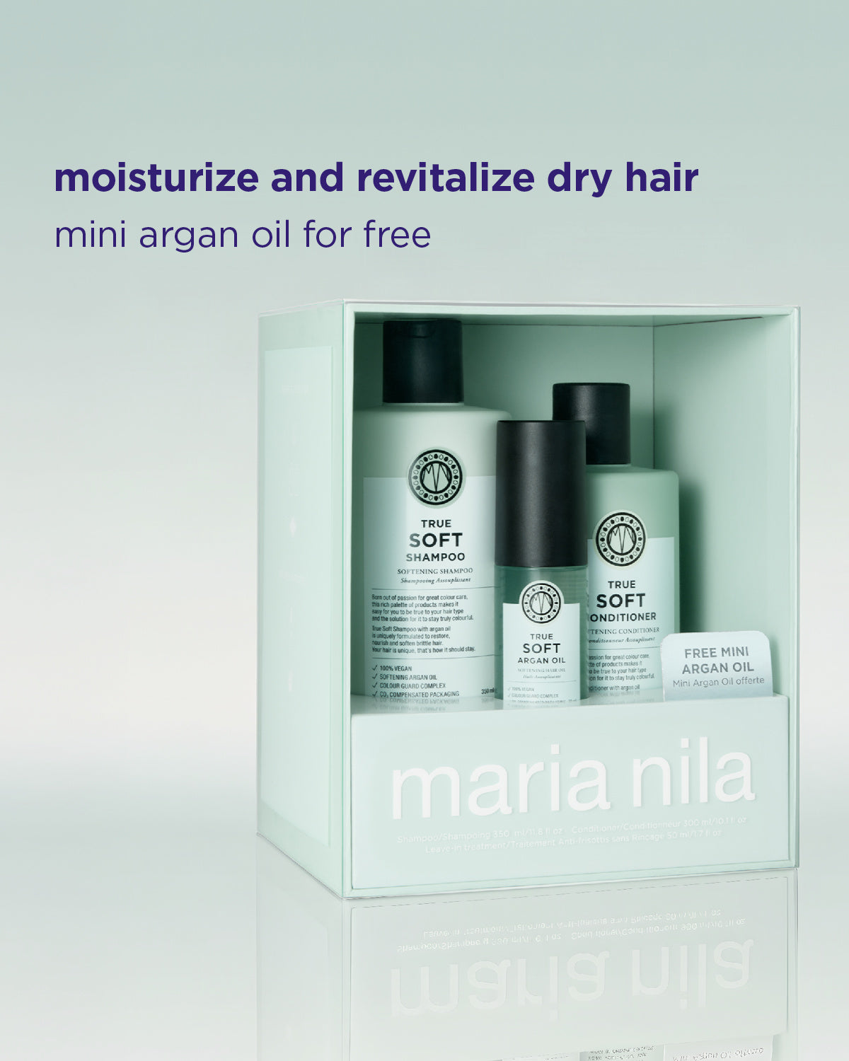 Maria Nila True Soft hair care set in a pale mint green box, featuring shampoo, conditioner, and a small free mini argan oil card, with promotional text above on a light gradient background.